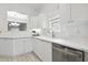 Bright kitchen featuring white cabinets, quartz countertops, stainless steel appliances, and tiled flooring at 149 Hutson Ln, Clayton, NC 27527