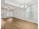 Bright living room with wood floors, fan, large windows, modern chandelier and neutral color palette at 149 Hutson Ln, Clayton, NC 27527