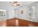 Spacious main bedroom with hardwood floors, two windows, and ensuite bathroom at 149 Hutson Ln, Clayton, NC 27527