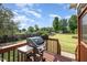 Cozy back deck featuring a grill, perfect for outdoor cooking and entertaining with a view of the spacious fenced yard at 174 Tafton Dr, Wendell, NC 27591