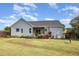 View of the back of the house, with a screened porch and large yard at 174 Tafton Dr, Wendell, NC 27591