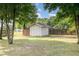 Backyard featuring a shed with light grey siding and a white door nestled in a fenced yard at 174 Tafton Dr, Wendell, NC 27591