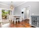 Open dining room with wood floors, contemporary light fixture, and sliding doors to the backyard deck at 174 Tafton Dr, Wendell, NC 27591