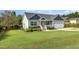 Inviting one-story home with manicured lawn, white porch, flower beds, and attached two-car garage at 174 Tafton Dr, Wendell, NC 27591