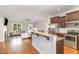 Open-concept kitchen and living room featuring granite counter bar and stainless appliances at 174 Tafton Dr, Wendell, NC 27591