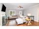 Cozy living room featuring a fireplace, hardwood floors, neutral colors, and natural light from a large window at 174 Tafton Dr, Wendell, NC 27591