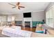 Bright living room featuring a fireplace, ceiling fan, hardwood floors, and ample seating at 174 Tafton Dr, Wendell, NC 27591