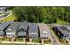 A lovely aerial view of craftsman homes shows their roofs and close proximity to mature trees at 190 Wendover Pkwy, Pittsboro, NC 27312