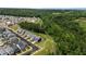 An aerial view shows homes, a winding road, and trees overlooking a forest at 190 Wendover Pkwy, Pittsboro, NC 27312