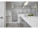 Well-lit bathroom featuring a tiled shower with glass doors, a modern vanity, and contemporary fixtures at 190 Wendover Pkwy, Pittsboro, NC 27312