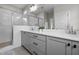 Contemporary bathroom featuring double sinks, gray cabinetry, and a glass-enclosed shower for a spa-like experience at 190 Wendover Pkwy, Pittsboro, NC 27312