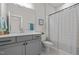 Bright bathroom featuring a modern vanity, toilet, and stylish shower curtain, creating a clean and functional space at 190 Wendover Pkwy, Pittsboro, NC 27312