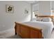 Cozy bedroom with a wood-frame bed, soft carpeting, and a window that fills the room with natural light at 190 Wendover Pkwy, Pittsboro, NC 27312
