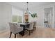 Charming dining room with wood floors, stylish chandelier, and elegant decor; perfect for Gathering gatherings and dinner parties at 190 Wendover Pkwy, Pittsboro, NC 27312