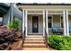 The home's front porch includes black railings, a black front door, and manicured landscaping at 190 Wendover Pkwy, Pittsboro, NC 27312