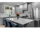 Bright, modern kitchen with stainless steel appliances and kitchen island with seating at 190 Wendover Pkwy, Pittsboro, NC 27312