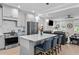 Modern kitchen with stainless steel appliances, island seating and open to living room at 190 Wendover Pkwy, Pittsboro, NC 27312