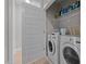 Functional laundry room with washer, dryer, storage shelves, and adjacent utility sink at 190 Wendover Pkwy, Pittsboro, NC 27312