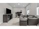 Versatile living area with a comfortable sofa, dedicated workspace, and entertainment setup for modern living at 190 Wendover Pkwy, Pittsboro, NC 27312