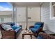 Relaxing screened porch with wicker furniture, blue cushions, and wooden flooring at 190 Wendover Pkwy, Pittsboro, NC 27312