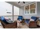 Inviting screened porch featuring wicker furniture, blue cushions, and a ceiling fan at 190 Wendover Pkwy, Pittsboro, NC 27312