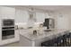 Modern kitchen featuring white cabinetry, granite countertops, and stainless steel appliances at 2000 Kapalua Way # 187, Durham, NC 27703