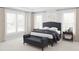 Serene main bedroom with large windows, neutral carpet, and stylish matching bedside tables at 2000 Kapalua Way # 187, Durham, NC 27703