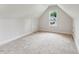 Clean attic space with carpeting, a window, and a door at 2028 Pleasant Forest Way, Wake Forest, NC 27587