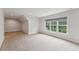 Finished attic space with carpet, recessed lighting, and a large window at 2028 Pleasant Forest Way, Wake Forest, NC 27587