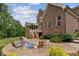 Brick home with a patio area including an outdoor fire pit and seating at 2028 Pleasant Forest Way, Wake Forest, NC 27587