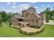 Expansive backyard with patio, screened porch, lush landscaping, and an inviting outdoor space for entertaining at 2028 Pleasant Forest Way, Wake Forest, NC 27587