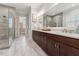 Modern bathroom featuring a glass shower, a dark wood vanity, and a large mirror above the sink at 2028 Pleasant Forest Way, Wake Forest, NC 27587