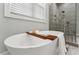 Modern bathroom featuring a free-standing white tub and a large glass shower at 2028 Pleasant Forest Way, Wake Forest, NC 27587