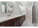 Modern bathroom with double vanities, elegant mirrors, and a glass-enclosed shower, offering a luxurious experience at 2028 Pleasant Forest Way, Wake Forest, NC 27587