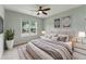 Cozy bedroom featuring a comfortable bed, stylish decor, and a bright window with a view of the neighborhood at 2028 Pleasant Forest Way, Wake Forest, NC 27587