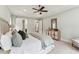 Bedroom featuring a queen-sized bed with decorative pillows, a ceiling fan, and a light-colored dresser at 2028 Pleasant Forest Way, Wake Forest, NC 27587