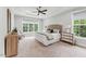 Serene bedroom with soft blue walls, neutral carpet, and a large window offering a calming view of nature at 2028 Pleasant Forest Way, Wake Forest, NC 27587