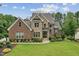 Beautiful home with brick and stone facade, well-maintained lawn, and professional landscaping at 2028 Pleasant Forest Way, Wake Forest, NC 27587