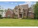 Beautiful two-story home with manicured front lawn and stone and brick facade at 2028 Pleasant Forest Way, Wake Forest, NC 27587
