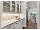 Bright kitchen features stone backsplash, white cabinets, stainless steel appliances, and dark hardwood flooring at 2028 Pleasant Forest Way, Wake Forest, NC 27587