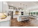 Open kitchen boasts stainless steel appliances, expansive island with seating, and a bright dining area at 2028 Pleasant Forest Way, Wake Forest, NC 27587