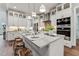 Bright, modern kitchen with white cabinetry, marble countertops, stainless steel appliances, and a stylish island with seating at 2028 Pleasant Forest Way, Wake Forest, NC 27587