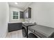 Modern laundry room with gray cabinets and stainless steel washer and dryer at 2028 Pleasant Forest Way, Wake Forest, NC 27587