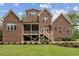 Brick two-story home featuring a screened-in porch and well-maintained lawn at 2028 Pleasant Forest Way, Wake Forest, NC 27587