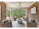 Cozy screened porch with comfortable seating, offering a peaceful outdoor living space with views of the surrounding woods at 2028 Pleasant Forest Way, Wake Forest, NC 27587