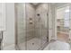 A glass shower with stone look tiling and a view of an open closet in the background at 2028 Pleasant Forest Way, Wake Forest, NC 27587