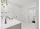 Clean bathroom featuring a single sink vanity and a large mirror with modern lighting at 204 Woodstaff Ave, Wake Forest, NC 27587
