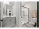 This bathroom features a walk-in shower, white marbled floors and countertops, plus a gray vanity at 204 Woodstaff Ave, Wake Forest, NC 27587