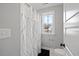 Bright bathroom featuring a tub and shower combination with a window view at 204 Woodstaff Ave, Wake Forest, NC 27587