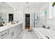 Bright bathroom with large vanity, marble flooring, walk in shower, soaking tub, and large walk-in closet at 204 Woodstaff Ave, Wake Forest, NC 27587
